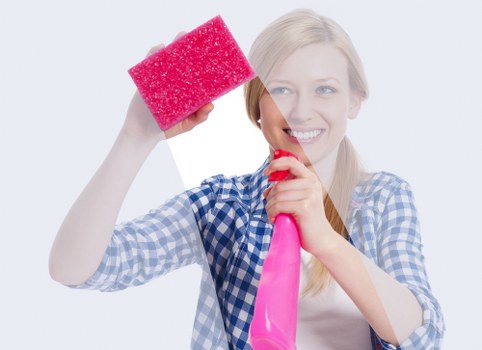 Worker lifting carpet cleaning equipment using proper manual handling technique